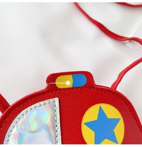 Detailed macro view of red car-shaped crossbody bag with star pattern and rainbow stitching