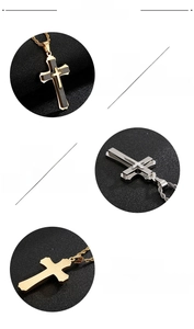 Detail view of 316L stainless steel cross pendant with silver and gold tiered design