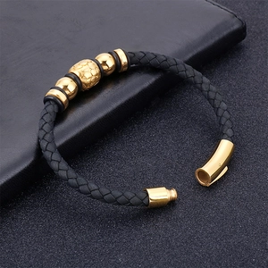 Men's braided black leather bracelet with golden textured beads and magnetic clasp