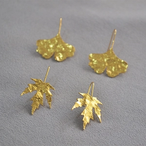 Gold leaf drop earrings featuring ginkgo and maple designs with hammered texture