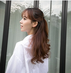 Detail of elegant pearl ear cuffs and studs set on a model wearing a white shirt