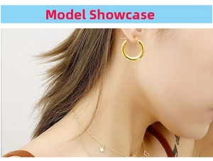 Close-up of thick 18k gold-plated stainless steel hoop earrings worn by a model