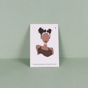 Minimalist small stud earrings displayed on elegant white paper card packaging
