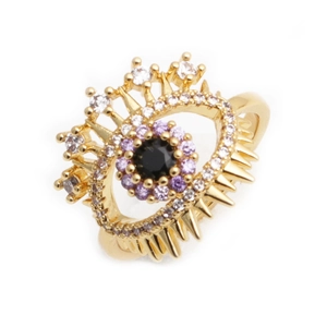 Gold evil eye ring with purple and black zircon crystals on a minimalist white background