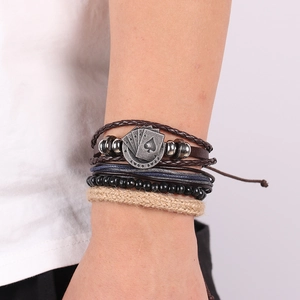 Detail of vintage multilayer leather bracelet with silver spade poker card charm for men