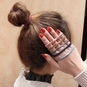 Detailed view of elastic hair bands in brown, beige and blue tones for women