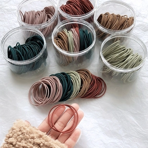 Close-up of durable high-elastic hair ties in various colors like pink and olive green