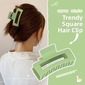 Detailed view of a sage green matte rectangular claw clip in a minimalist geometric design