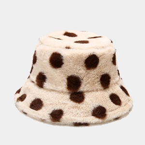 Detailed macro shot of soft plush faux fur texture on a beige polka dot bucket hat