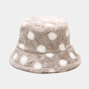 Close-up of beige plush bucket hat with white polka dots showing soft fuzzy texture