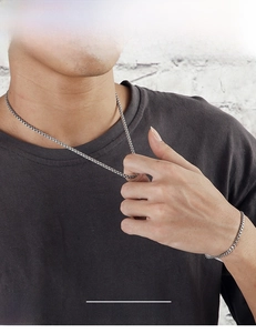Detail of 3.5mm stainless steel box chain necklace and bracelet set on male model