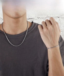Male model wearing silver stainless steel box chain necklace and bracelet set