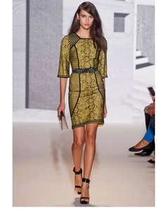 Detailed close-up of a blue beaded waist belt on a yellow snake print dress with black trim