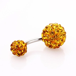 Macro shot of silver belly button ring with 5mm and 8mm sparkling yellow crystals