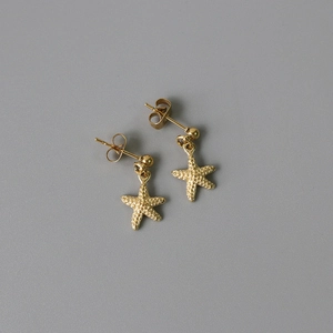 Starfish drop earrings in 14K gold plated titanium steel with granular texture detail