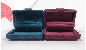 Detail of teal and burgundy velvet jewelry organizers for earrings and necklaces
