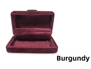 Detail view of wine red velvet jewelry box with golden metal clasp and inner cushion