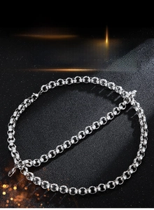 Close-up of 9mm titanium steel cuban link chain set with lobster clasp on black surface
