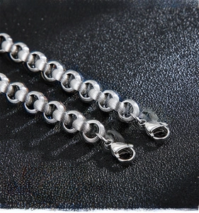Detailed close-up of durable silver stainless steel lobster clasps and textured chain links