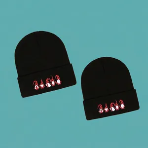 Knitted Santa Claus beanies in black with gnome embroidery for Christmas warmth