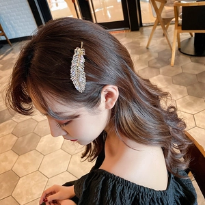 Sparkling crystal feather hair clip in gold finish for elegant women hairstyles