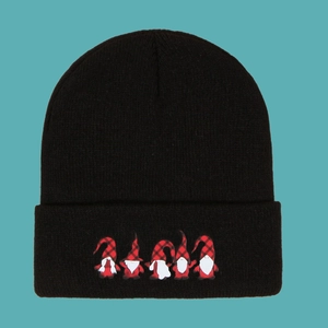 Close-up of black knitted beanie with Nordic gnomes print and buffalo plaid details