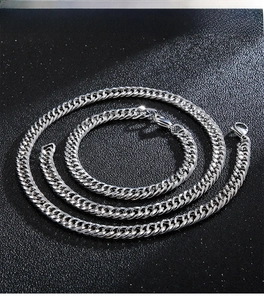 Detailed view of polished stainless steel curb chain set with lobster clasps