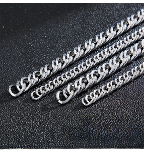 Detailed close-up of polished silver Cuban chain links with precision craftsmanship