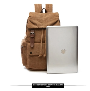 Size comparison of the brown canvas backpack next to an iPad on a plain background