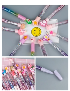 Detail of colorful liquid quicksand pens with glitter and cute cartoon animal toppers