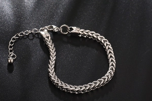 Detail of silver stainless steel wheat chain bracelet with lobster clasp and extender