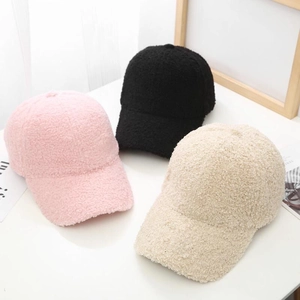 Detailed flat lay of soft fleece baseball caps in pink, black, and beige winter colors