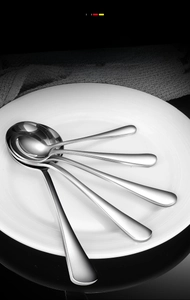 Close-up of five large-capacity stainless steel spoons with smooth edges and polished finish
