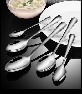 Detailed view of five varied sizes stainless steel spoons set on a glossy black surface
