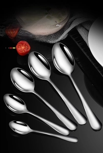Detailed view of 5-piece polished stainless steel spoon set on a black reflective surface