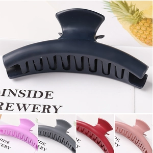 Detail of matte hair claws in navy blue, rose pink, and dark grey for stylish hair styling