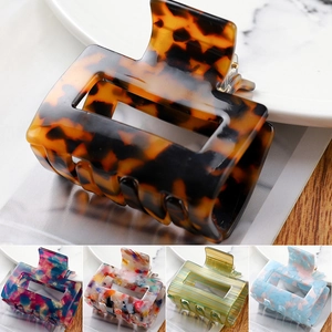 Detail shot of square acetate hair claw clips in tortoiseshell and marble patterns