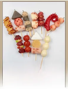 Macro view of various realistic food pendants including skewers and octopus tentacles