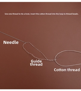Detail of PONY beading needle with white cotton thread and translucent needle threader tool