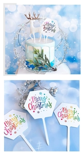 Detail of LED Christmas cake topper with glowing Merry Christmas text on a blue cake