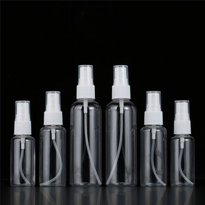 Detailed row of six transparent PET spray bottles with white pumps against dark backdrop