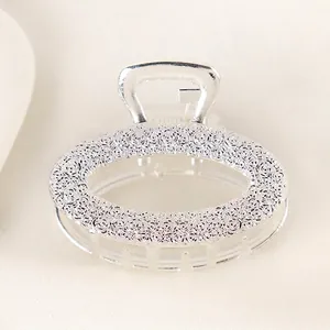 Detail of silver alloy hair claw clip featuring elegant rose embossed floral patterns