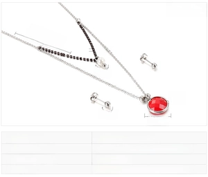 Detail view of double-layer stainless steel necklace set with red faceted glass pendant