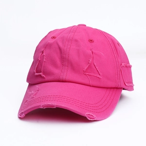 Detailed close-up of distressed cotton baseball cap in rose pink with raw edge rips