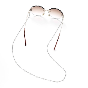 Detail of scalloped gradient sunglasses with a delicate pearl chain strap attachment