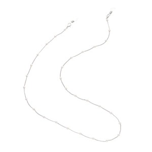 Close-up of a silver glasses chain with white pearls and anti-slip silicone loops