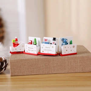 Wooden Christmas train ornament with Santa and snowman figures on a decorative red base