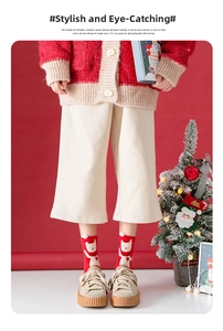 Detail of red Christmas crew socks featuring a cute white 3D cartoon bear pattern