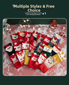 Flat lay of colorful Christmas socks featuring Santa and reindeer designs with snow props