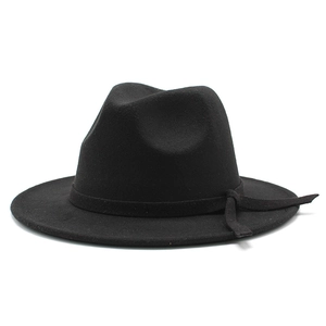 Close-up of black wool fedora hat featuring matching ribbon and side strap detail